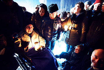 Dario Gabbai lights a memorial candle at Auschwitz on Jan. 27, 2015